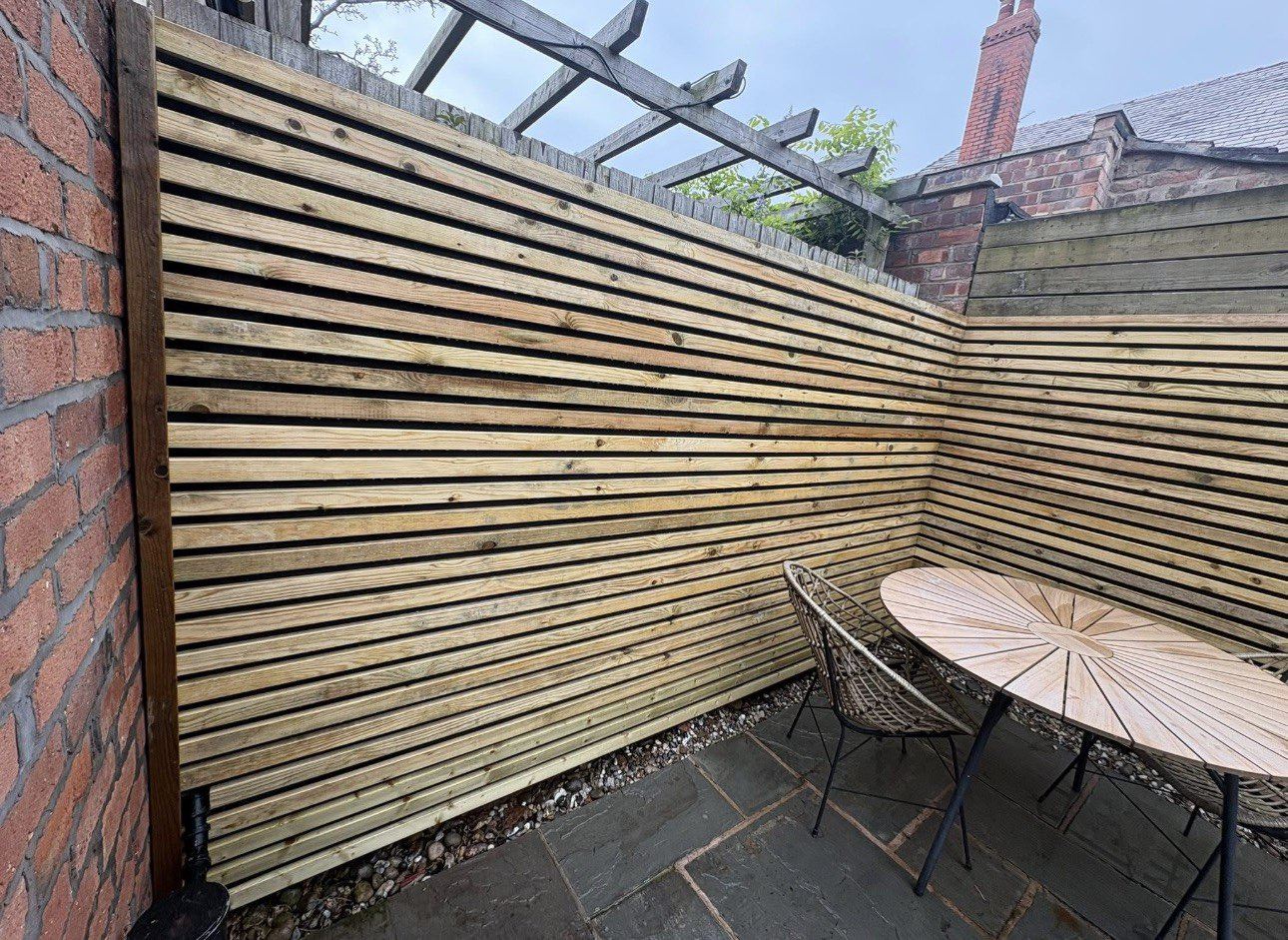Contemporary slatted fence beside a patio in Liverpool