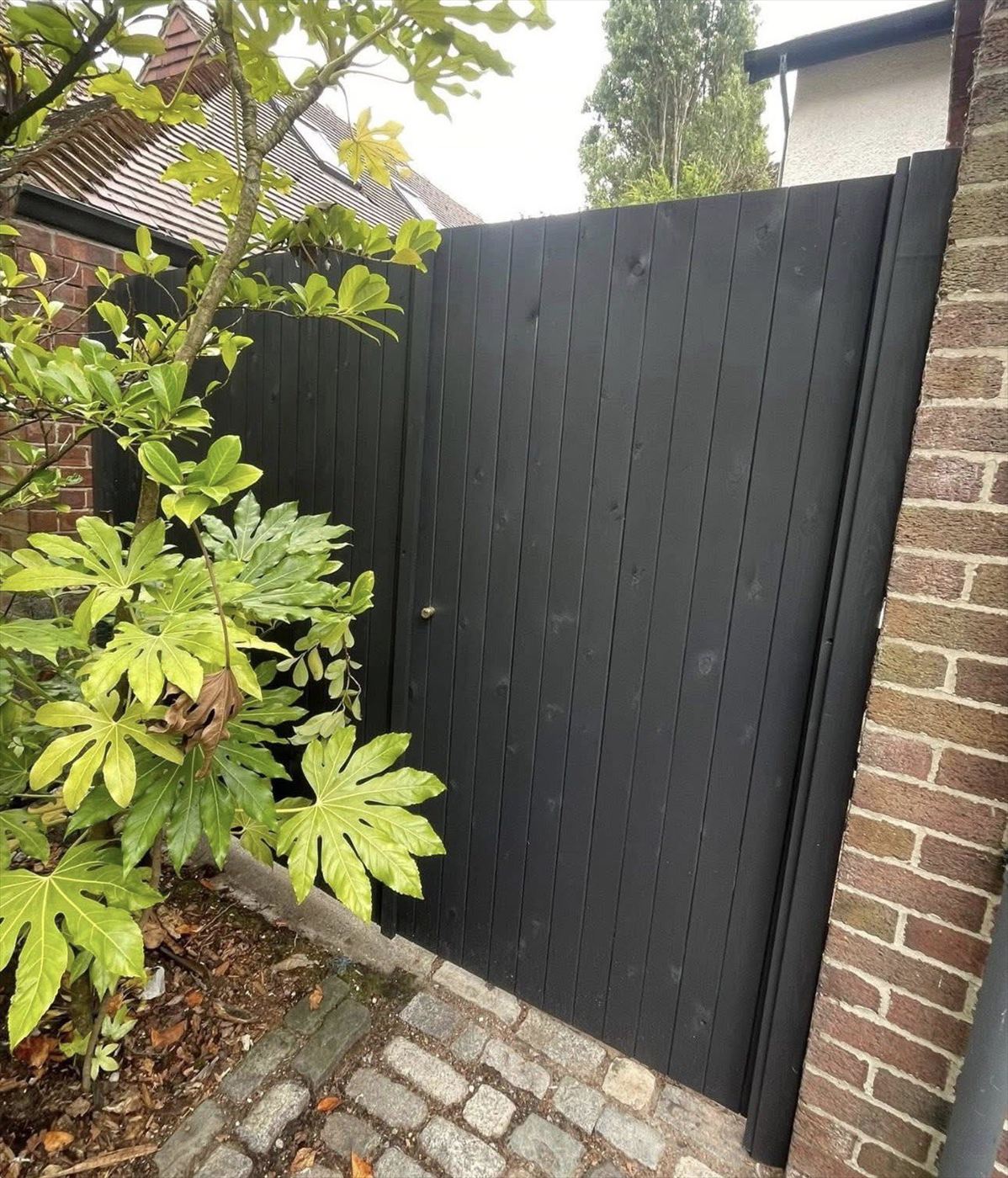 Timber gate and fence painted black by AJ Garden Services